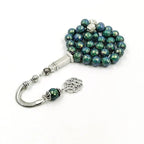 Color-shift tasbih misbaha with green-blue beads, rectangular silver charm, and tassel ends