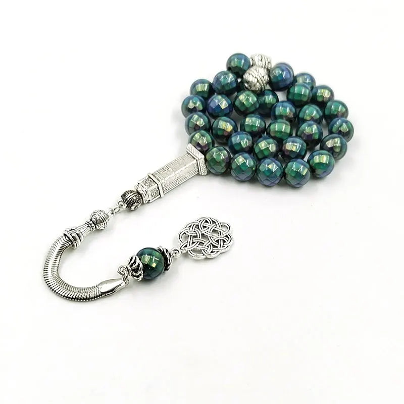 Color-shift tasbih misbaha with green-blue beads, rectangular silver charm, and tassel ends