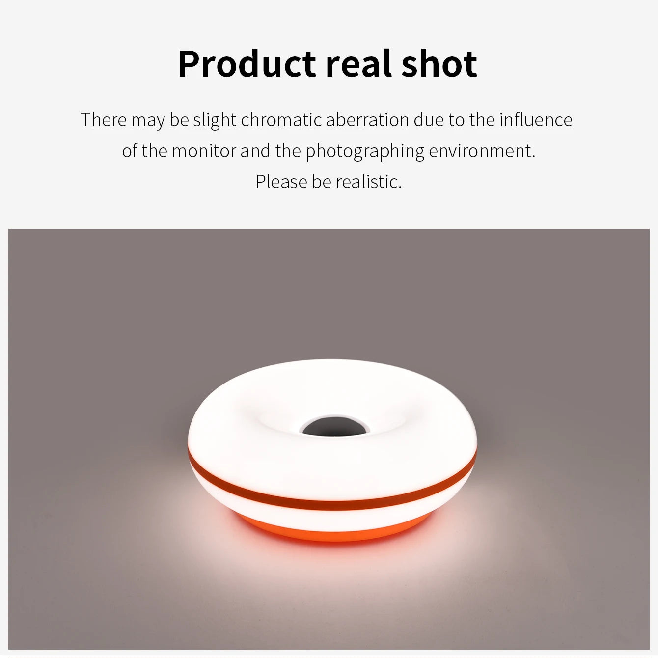 White donut table lamp with amber glow from center, orange outer rim.