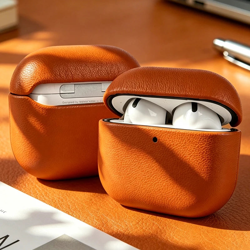 Tan eco-leather AirPods case with lid open, showing earbuds inside