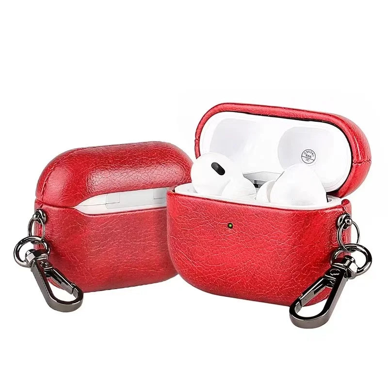 Bordeaux red metal keychain AirPods case with lid open and white earbuds inside