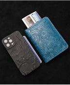 Midnight Blue leather travel folio with embossed flowers, flat lay with passport cover