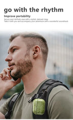 Emerald green crocodile-grain AirPods case with carabiner keychain on a backpack strap.