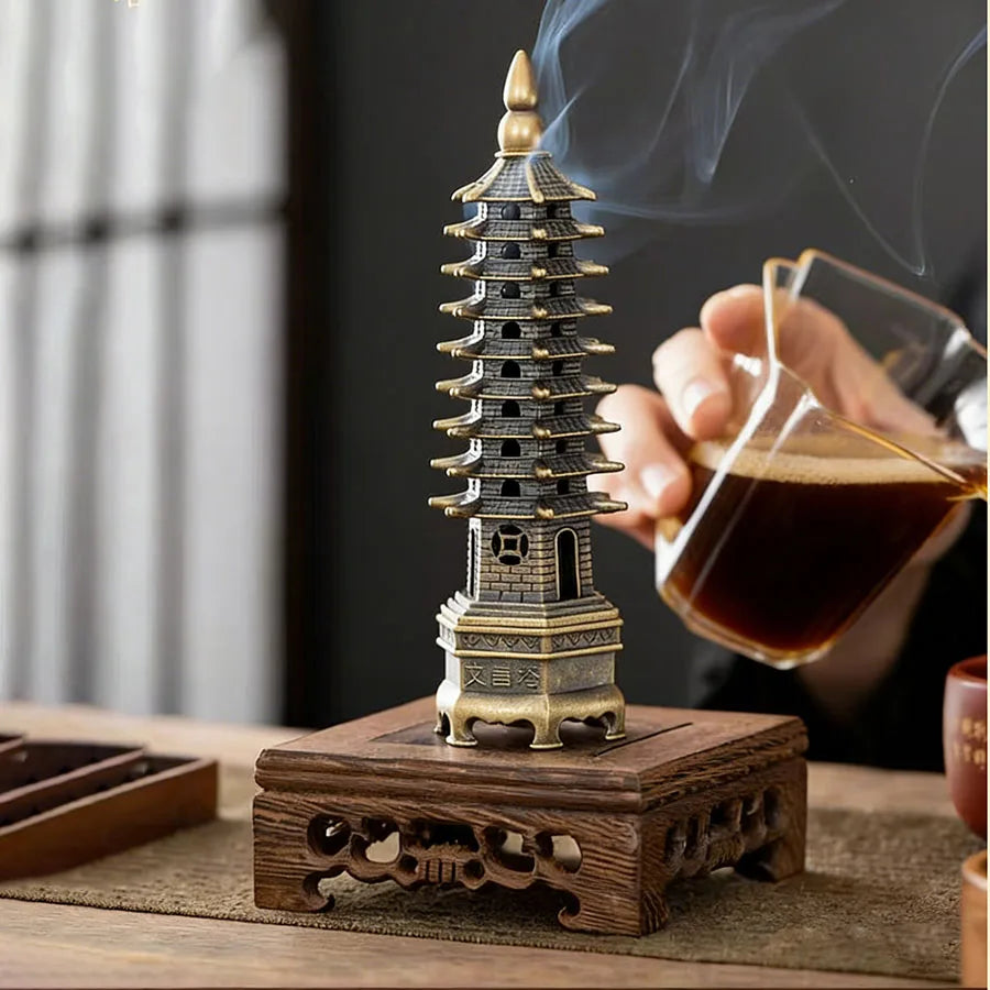Tower incense stand with burning incense rising from the top opening