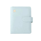 Light blue passport folio with gold airplane emblem and wrap-around strap closure