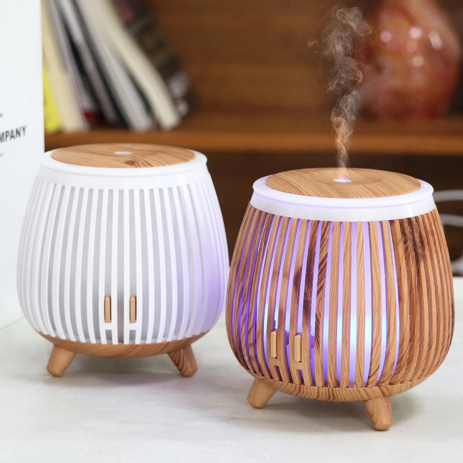 Wood-grain aroma diffuser humidifier with white base, striped sides, and mist output