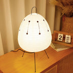 Paper lantern bedside lamp with white shade, black tripod legs, hanging dotted line decor