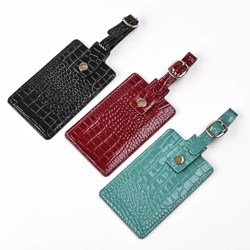 Croc-texture passport covers in Midnight Black, Burgundy, and Forest Green with straps