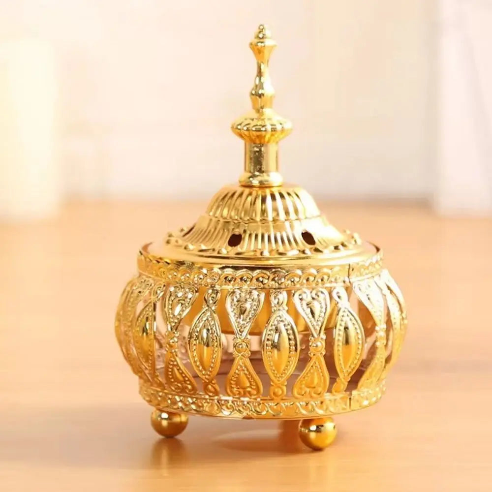 Front view of gold Arabian incense holder with scalloped dome and vent holes