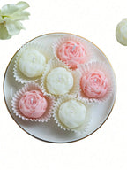 Floral candle set: ivory and pale pink rose-shaped candles on round tray