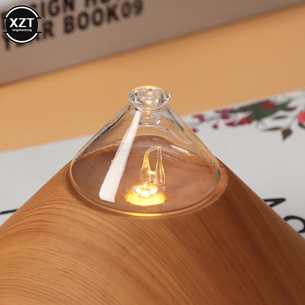 Wood grain aroma diffuser close-up with glowing bulb inside clear glass top