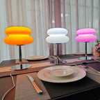Mushroom USB ambient table lamp on desk with multi-color lighting: orange, white, and pink.
