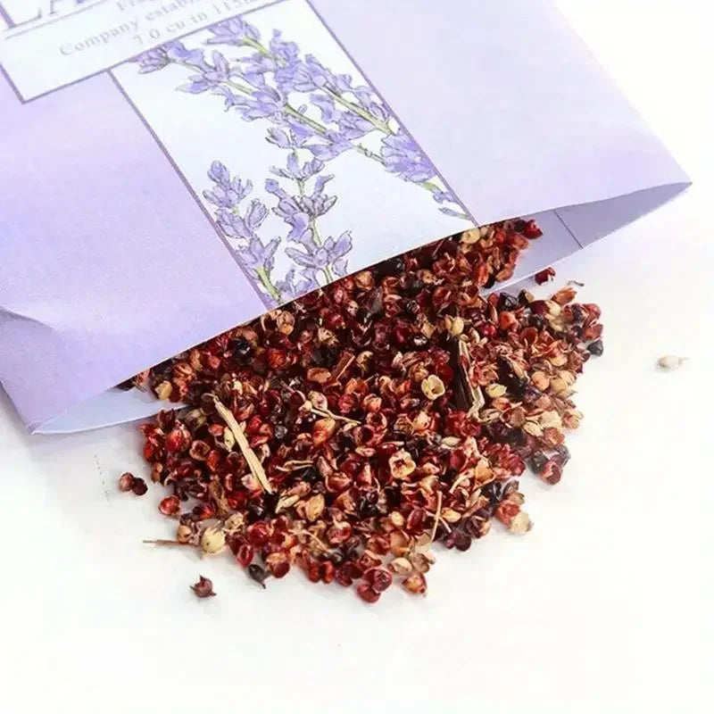 Opened sachet with dried floral fragrance mix on white surface