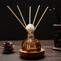 Floral reed diffuser set in amber glass bottle with 5 light wooden reeds