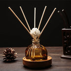 Floral reed diffuser set in amber glass bottle with 5 light wooden reeds