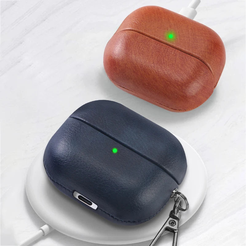 Cognac orange and dark navy leather AirPods cases with green LED dot and key ring