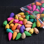 Mixed-color backflow incense cones set, with cones scattered and in a clear bag