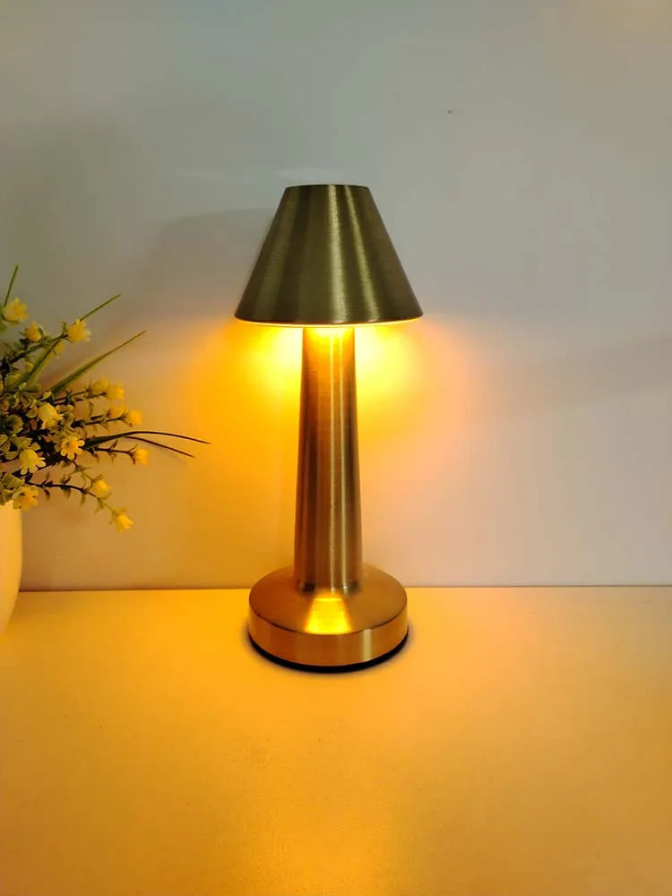 Retro cordless LED table lamp with gold dome shade and warm light glow