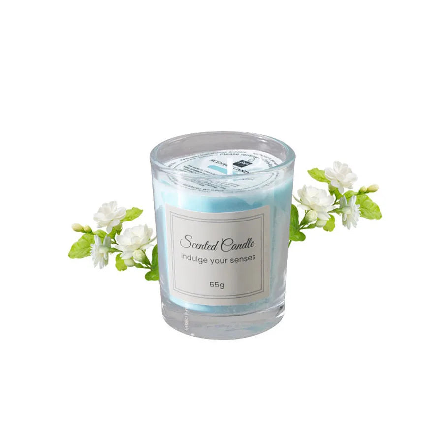 Light blue glass scented candle with white flowers, gift-ready