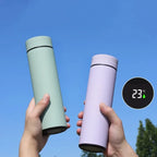 Insulated thermos bottles, mint and lavender, with black base lids and holders in hands
