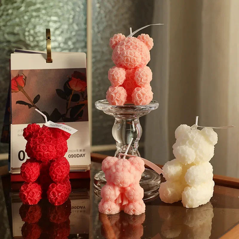 Rose bear scented candle set: pink, red, and ivory bear candles on a glass holder