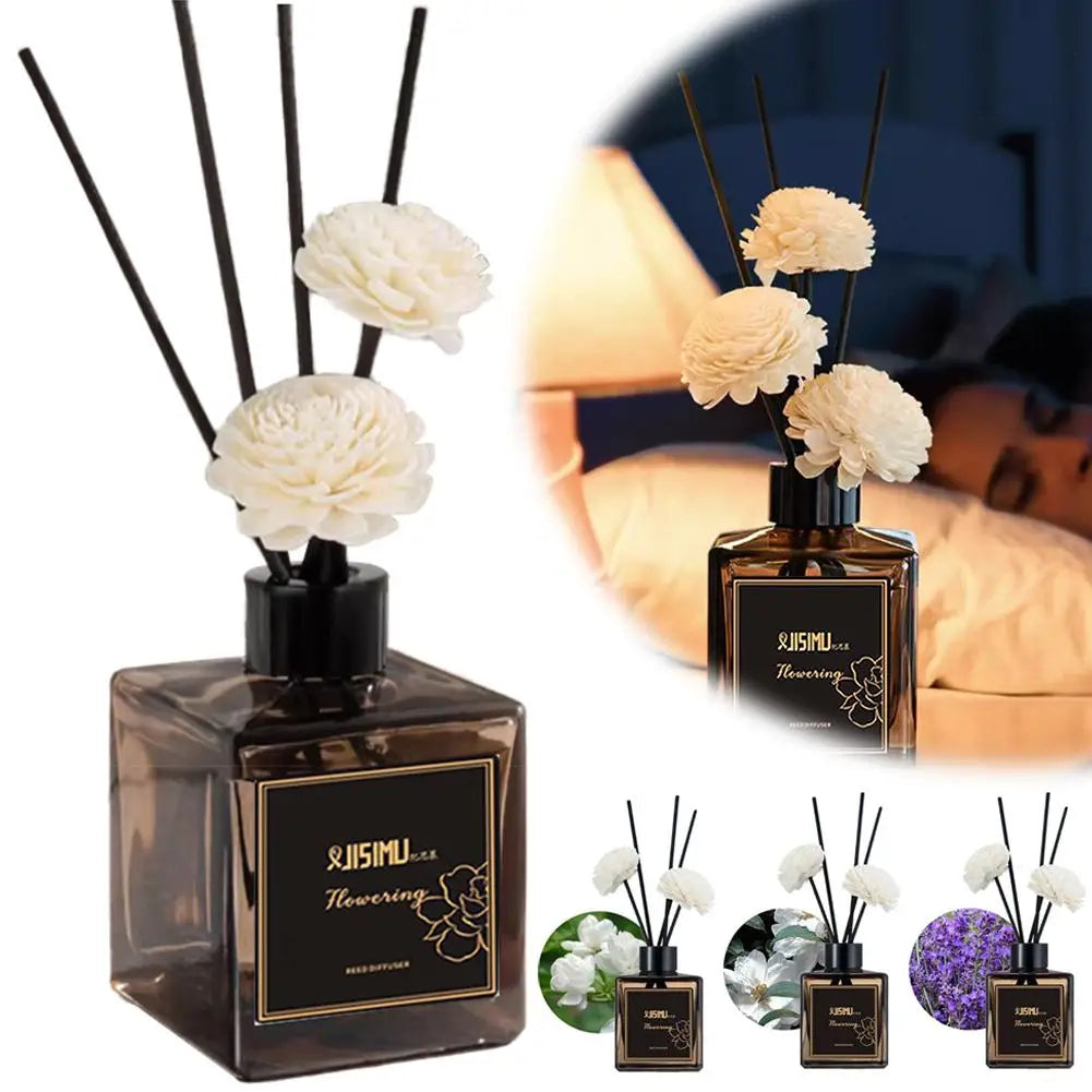 Reed diffuser bottle with black reeds and white flowers beside a smaller set display
