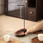 Walnut-black inverted incense holder with incense stick on round base