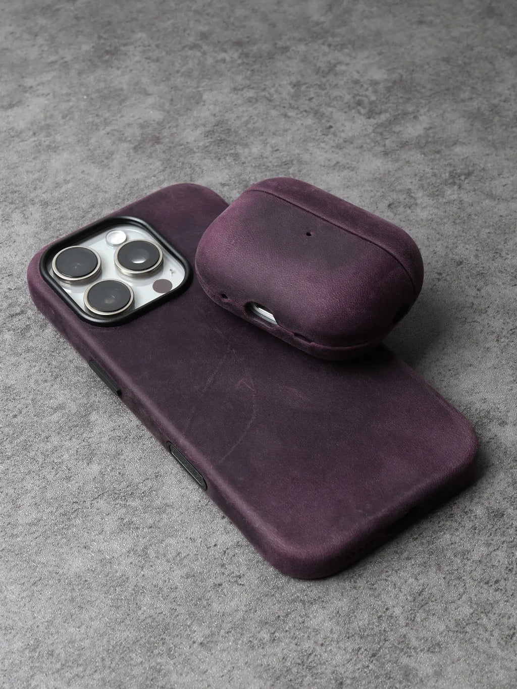Purple leather AirPods case with curved lid and bottom port cutout