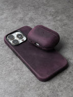 Purple leather AirPods case with curved lid and bottom port cutout