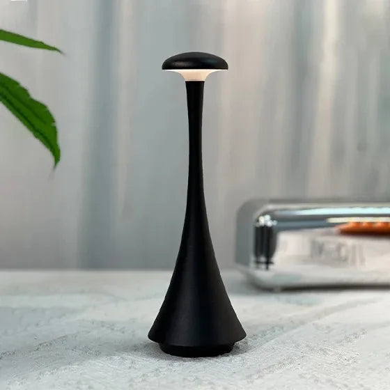 Obsidian black cordless mushroom touch table lamp with tapered body and circular top diffuser.