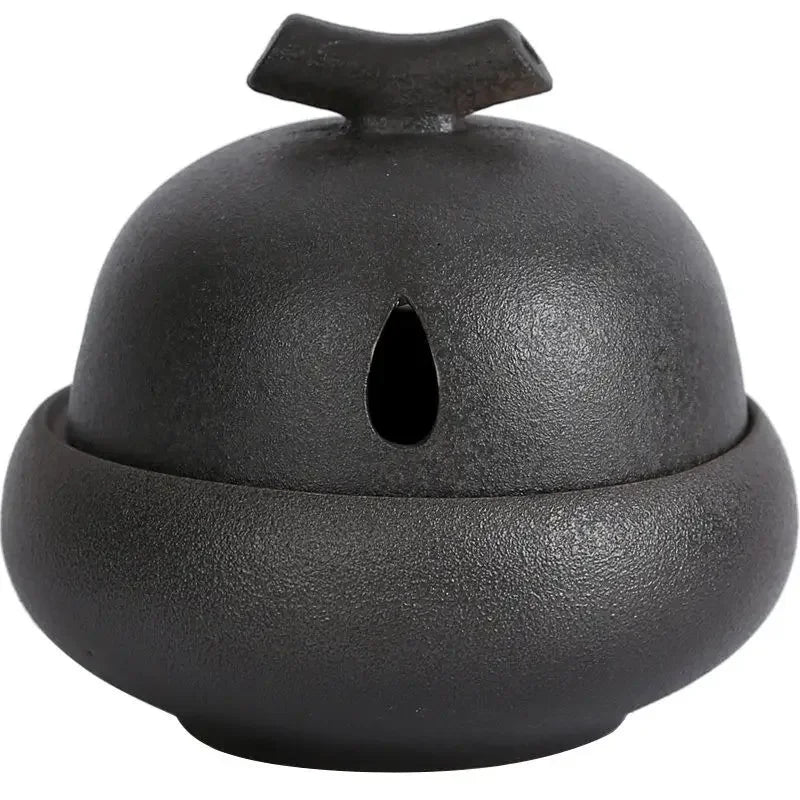 Ash glaze dark grey ceramic incense stove with central oval opening and flared top