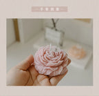 Peony sculptural scented candle held in hand, pastel pink flower with wick