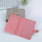 Slate grey vegan leather passport holder with card slots and snap-button closure