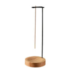 Inverted wooden incense tray on white background: round base and black metal stand