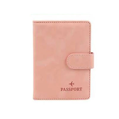 Blush pink passport folio with side buckle tab, “PASSPORT” text, and embossed airplane