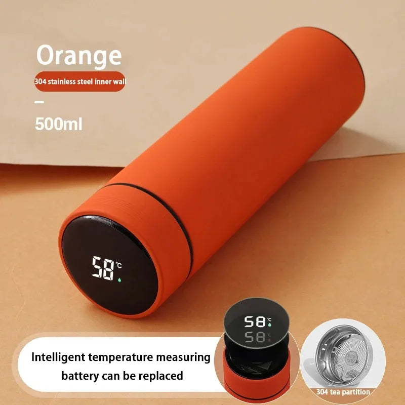 Orange smart thermos with digital temperature display and tea infuser accessory