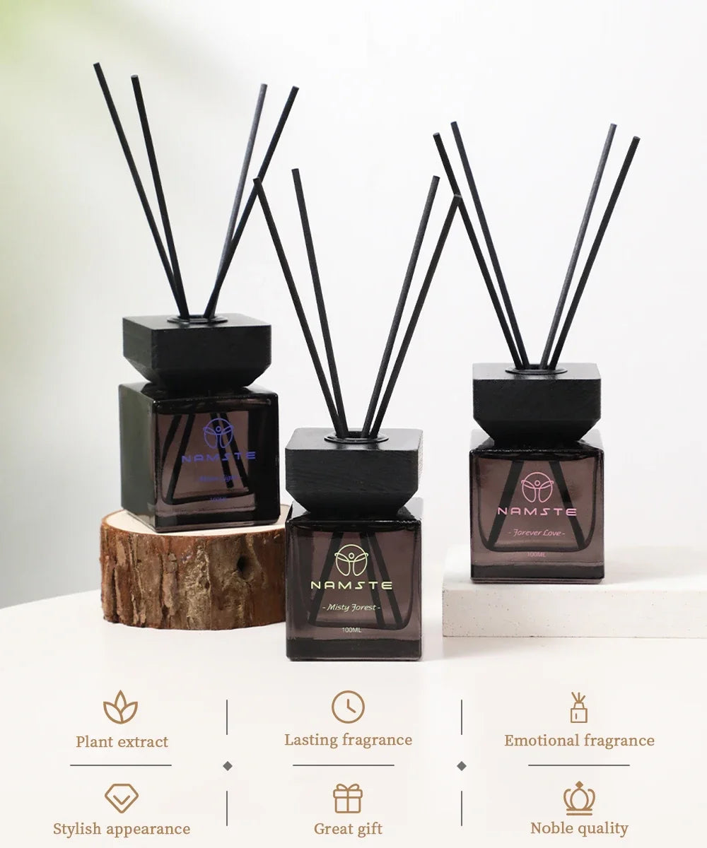 Reed diffuser set with several dark bottles and black reeds on display