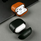 Warm brown eco leather AirPods case with earbuds, open lid, plus closed dark green case