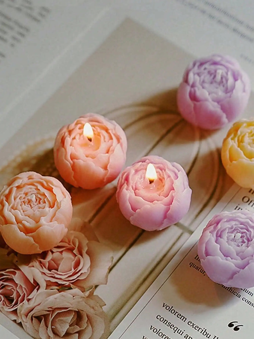 Floral candle set: glowing rose candles in peach, pink, and lavender tones