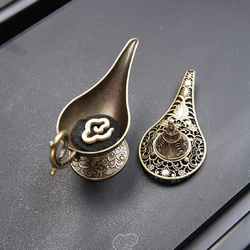 Two cone incense burner holders with engraved medallions and ornate metalwork