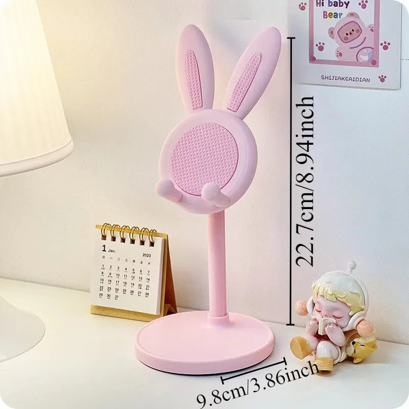 Blush pink rabbit phone stand with circular mesh face and two upright bunny ears