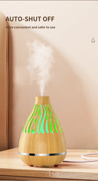 Wood-grain aroma diffuser humidifier with green LED vent lights and mist output.