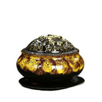 Ceramic incense burner with amber speckled glaze and ornate gold lid