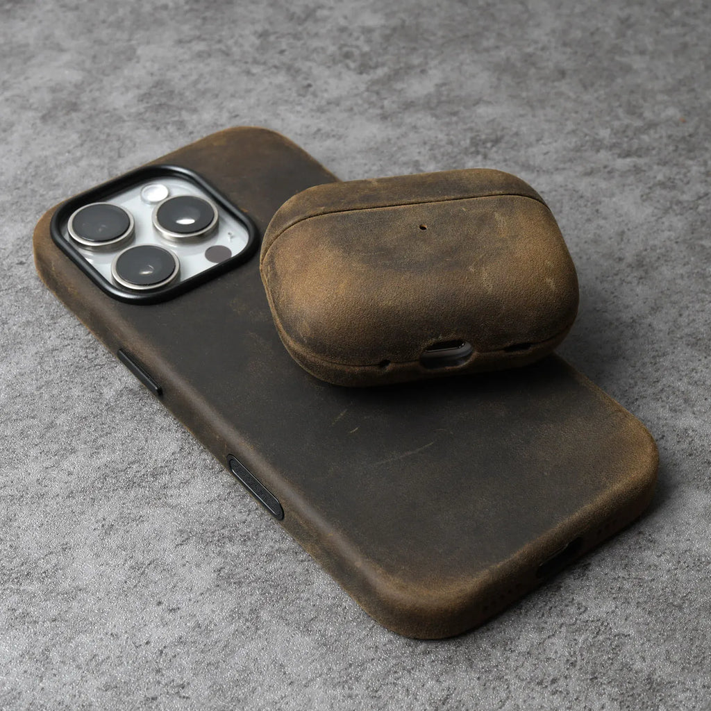 Olive-brown leather AirPods case with rounded lid and side charging cutout