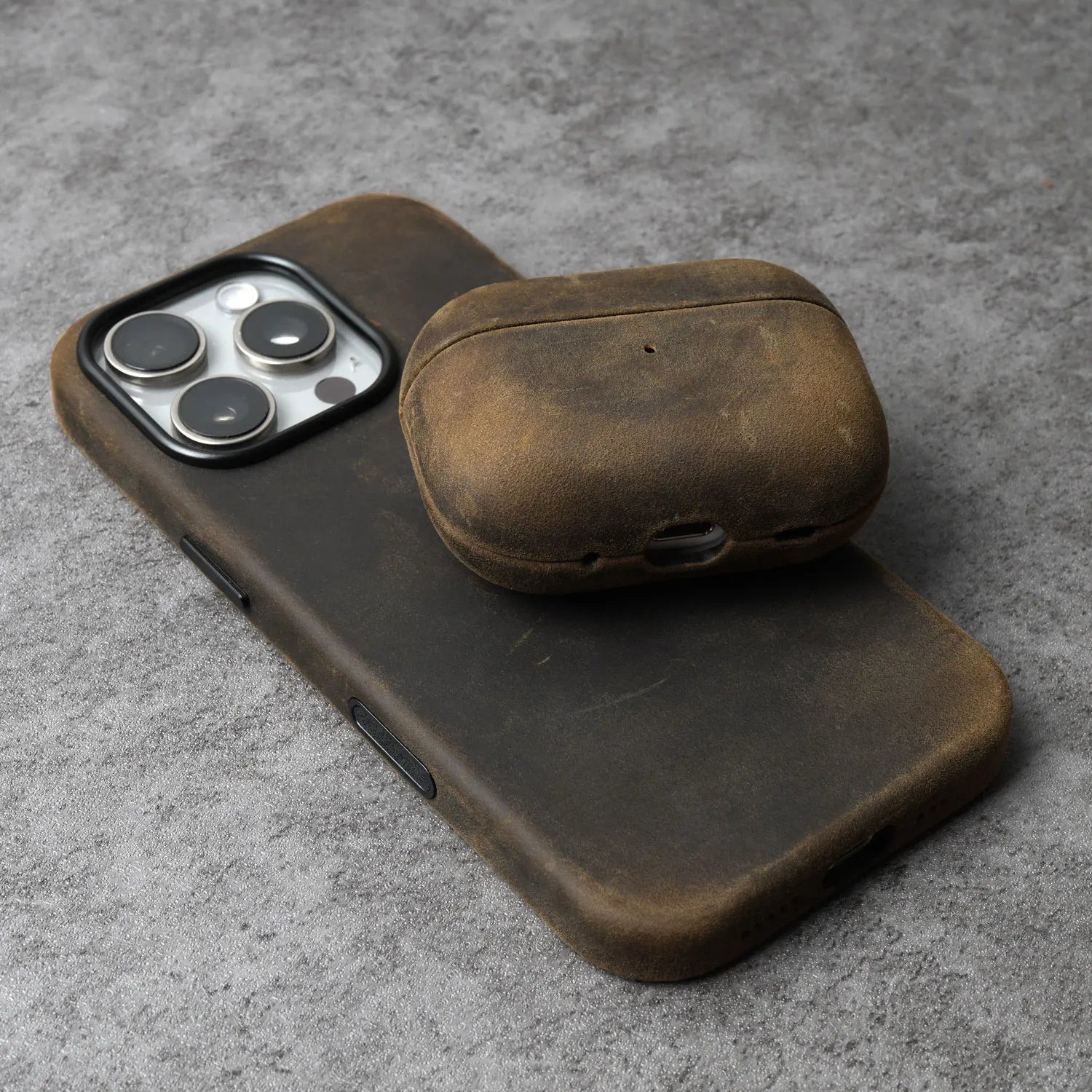 Olive-brown leather AirPods case with rounded lid and side charging cutout