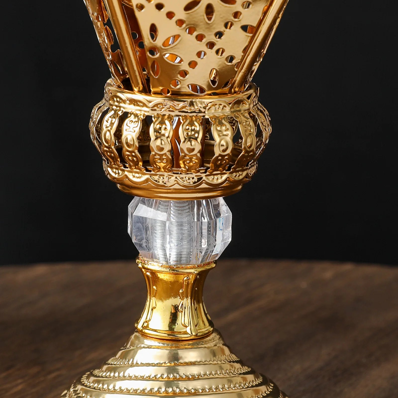 Brushed gold mabkhara close-up: perforated lantern body and engraved lower section