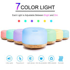 Set of 7-color aroma diffuser humidifiers with glowing lids and wood bases