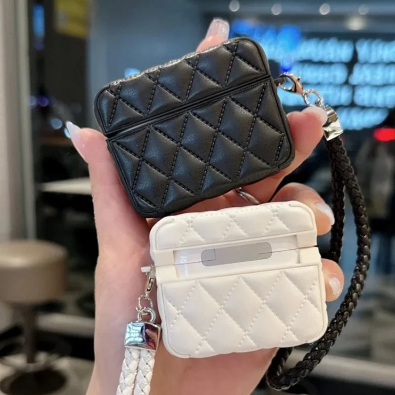 Quilted leather AirPods cases with lanyard straps—black on top, white below