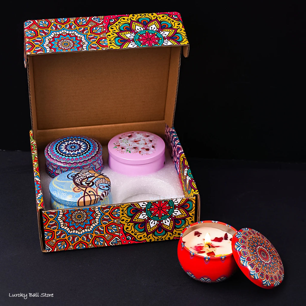 4 scented candle tins in a decorated gift box with one red and one pink lid