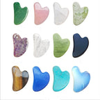 Assorted heart-shaped jade roller stones in multiple colors: green, pink, white, blue, purple, dark blue.